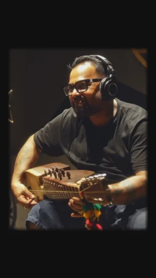 A session musician records a bowed string instrument during a Rushabh Ahir studio session