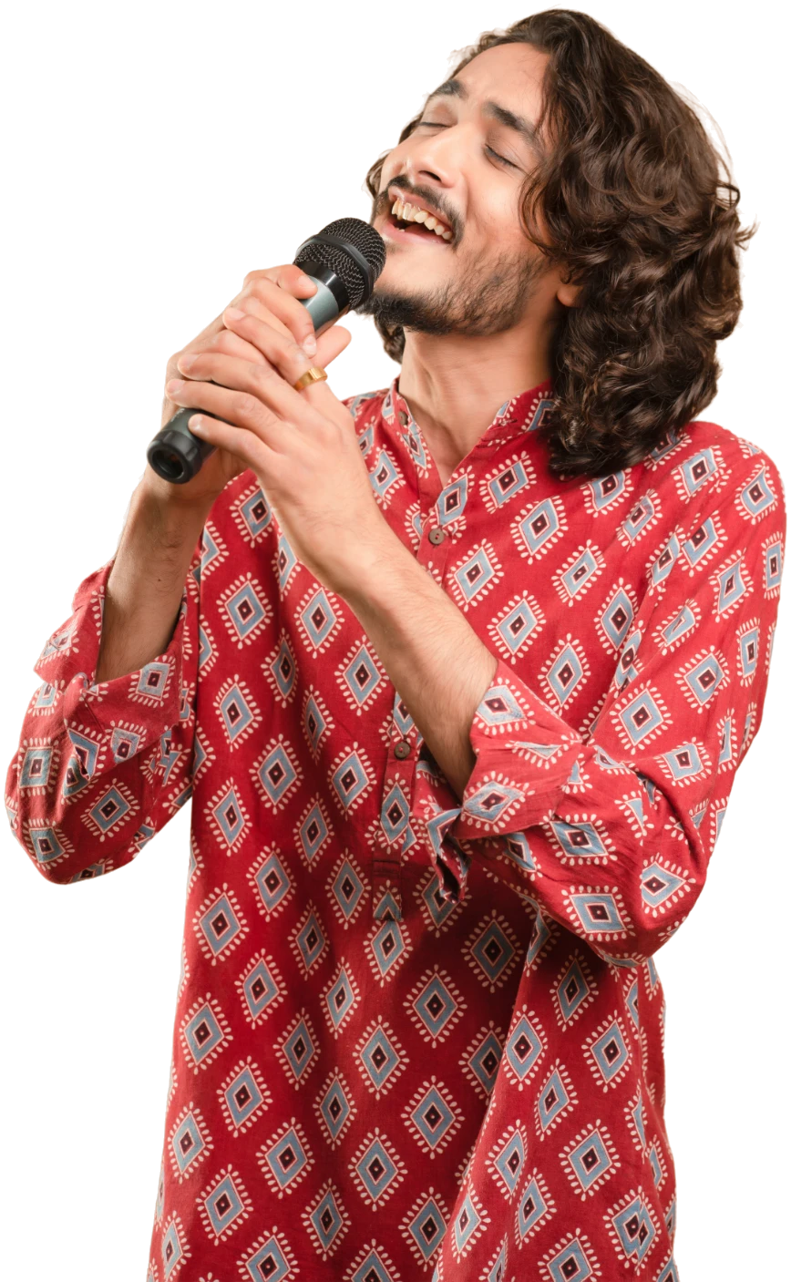 Rushabh Ahir singing into the microphone, eyes closed